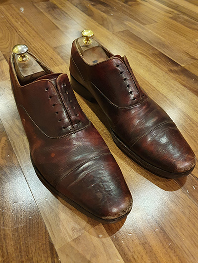 Pair of scuffed brown Shipton & Heneage shoes